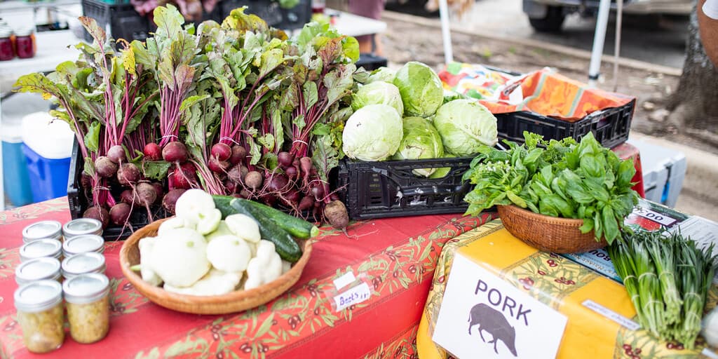 Fresh vegetables and local produce displayed at a farmers market